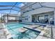 A private screened-in pool and spa with bar seating offers luxurious outdoor living at 3061 Hollow Hickory Pl, Wesley Chapel, FL 33543