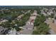Aerial shot of a home in a neighborhood with a pond, lush greenery and an arrow pointing towards the property at 12802 Cattail Shore Ln, Riverview, FL 33579