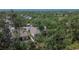 Overhead view of a house nestled among trees, showcasing a fenced backyard at 12802 Cattail Shore Ln, Riverview, FL 33579