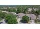 Aerial photo shows a home surrounded by lush trees in a suburban neighborhood, with well-kept lawns and paved driveways at 12802 Cattail Shore Ln, Riverview, FL 33579