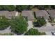 An aerial view shows a nicely landscaped property in a quiet neighborhood, with well-maintained lawns, trees and paved driveway at 12802 Cattail Shore Ln, Riverview, FL 33579