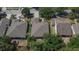 Aerial view of a well-maintained single Gathering home featuring a brown shingle roof and lush landscaping in a quiet neighborhood at 12802 Cattail Shore Ln, Riverview, FL 33579