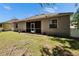 Rear exterior view of home with a screened patio and spacious backyard at 12802 Cattail Shore Ln, Riverview, FL 33579