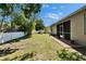 Spacious backyard with a well-maintained lawn, privacy fence, and mature landscaping at 12802 Cattail Shore Ln, Riverview, FL 33579