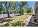 Large backyard featuring lush green grass, privacy fence, and a brick-paved walkway at 12802 Cattail Shore Ln, Riverview, FL 33579