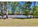 Spacious backyard features a well maintained lawn, mature trees, and a privacy fence at 12802 Cattail Shore Ln, Riverview, FL 33579