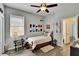 Bedroom with ceiling fan, wood floors, and lots of natural light at 12802 Cattail Shore Ln, Riverview, FL 33579
