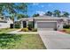 Attractive one-story home featuring a lush lawn and well-manicured landscaping at 12802 Cattail Shore Ln, Riverview, FL 33579