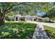 Landscaped front lawn showcasing a single-story home with a two car garage at 12802 Cattail Shore Ln, Riverview, FL 33579