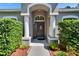 Inviting front entrance with decorative door and manicured shrubs at 12802 Cattail Shore Ln, Riverview, FL 33579