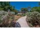 A peaceful gazebo is framed by lush foliage and a curved pathway, offering a tranquil escape at 12802 Cattail Shore Ln, Riverview, FL 33579