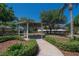 A charming gazebo nestled in a landscaped garden provides a serene outdoor retreat at 12802 Cattail Shore Ln, Riverview, FL 33579