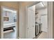 Hallway featuring laundry room with appliances and view of bedroom with wood floors at 12802 Cattail Shore Ln, Riverview, FL 33579