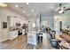 Open-concept kitchen with an island, white cabinets, and stainless steel appliances at 12802 Cattail Shore Ln, Riverview, FL 33579