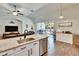 Bright kitchen with stainless steel appliances, granite counters, and open to the living area at 12802 Cattail Shore Ln, Riverview, FL 33579