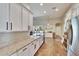 Beautiful kitchen with island seating, granite countertops, and sliding glass doors at 12802 Cattail Shore Ln, Riverview, FL 33579