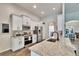 Bright kitchen features white cabinetry, granite countertops, and stainless steel appliances at 12802 Cattail Shore Ln, Riverview, FL 33579
