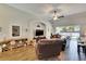 Spacious living room with wood-look tile flooring and sliding glass doors to the backyard at 12802 Cattail Shore Ln, Riverview, FL 33579