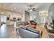 Inviting living room with tile floors, modern ceiling fan, and open layout to kitchen at 12802 Cattail Shore Ln, Riverview, FL 33579