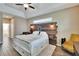 Spacious bedroom featuring a rustic wood headboard, tray ceiling, and wood-look floors at 12802 Cattail Shore Ln, Riverview, FL 33579
