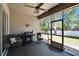 Relaxing screened patio features ceiling fan, outdoor seating and a grill, perfect for entertaining at 12802 Cattail Shore Ln, Riverview, FL 33579