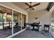 Relaxing screened patio with a ceiling fan, outdoor seating and a grill overlooking the backyard at 12802 Cattail Shore Ln, Riverview, FL 33579