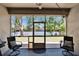 Comfortable screened patio with ceiling fan and outdoor seating looking out to the fenced backyard at 12802 Cattail Shore Ln, Riverview, FL 33579