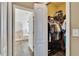 Walk-in closet leading to a bathroom, featuring organized storage and tiled floors at 12802 Cattail Shore Ln, Riverview, FL 33579