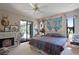 Well-lit bedroom with a fireplace and glass sliding doors that lead to the outdoor pool at 268 Cory St, Port Charlotte, FL 33953