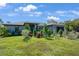 Well-manicured front yard with healthy green grass and a variety of shrubbery for added curb appeal at 268 Cory St, Port Charlotte, FL 33953