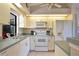 Efficient kitchen with white cabinets, appliances, neutral countertops, and tile flooring at 268 Cory St, Port Charlotte, FL 33953