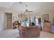 Comfortable living room featuring a ceiling fan, art, and access to backyard pool area through sliding doors at 268 Cory St, Port Charlotte, FL 33953
