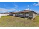 The backyard has ample space for outdoor activities, and features a sliding door and A/C unit at 10357 Scarlet Skimmer Dr, Riverview, FL 33578