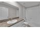Bright bathroom featuring granite counters, white cabinets, and a shower over tub at 10357 Scarlet Skimmer Dr, Riverview, FL 33578