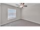 Empty bedroom with carpet flooring, ceiling fan and a window with blinds at 10357 Scarlet Skimmer Dr, Riverview, FL 33578