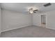 Spacious bedroom featuring soft carpeting and a stylish ceiling fan with light fixture at 10357 Scarlet Skimmer Dr, Riverview, FL 33578