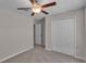 Cozy bedroom featuring a ceiling fan and double-door closet at 10357 Scarlet Skimmer Dr, Riverview, FL 33578