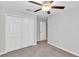 Carpeted bedroom with a ceiling fan and closet at 10357 Scarlet Skimmer Dr, Riverview, FL 33578