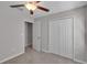 Cozy carpeted bedroom features a ceiling fan and large closet at 10357 Scarlet Skimmer Dr, Riverview, FL 33578