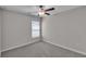 Carpeted bedroom featuring a ceiling fan and a window with blinds at 10357 Scarlet Skimmer Dr, Riverview, FL 33578