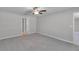 This bedroom boasts soft carpeting, a ceiling fan, and easy access to the en-suite bathroom at 10357 Scarlet Skimmer Dr, Riverview, FL 33578