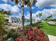 Enjoy lounging by the community pool lined with palm trees and lawn chairs under a bright blue sky at 10357 Scarlet Skimmer Dr, Riverview, FL 33578