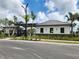 Community pool house with dark trim windows, mature landscaping, and a solar powered lamp post at 10357 Scarlet Skimmer Dr, Riverview, FL 33578