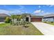 Charming home boasting lush landscaping and a well-manicured lawn at 10357 Scarlet Skimmer Dr, Riverview, FL 33578