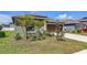 Well-maintained home featuring a two-car garage and mature landscaping at 10357 Scarlet Skimmer Dr, Riverview, FL 33578