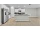 Bright kitchen features stainless steel appliances, granite countertops, and large island with sink at 10357 Scarlet Skimmer Dr, Riverview, FL 33578