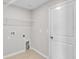 A simple laundry room space with tile floors and a storage shelf at 10357 Scarlet Skimmer Dr, Riverview, FL 33578