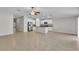 Open concept living room and kitchen features tile flooring and ample space for entertaining at 10357 Scarlet Skimmer Dr, Riverview, FL 33578