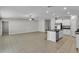 View of the open-concept living area and kitchen that features tile flooring throughout at 10357 Scarlet Skimmer Dr, Riverview, FL 33578