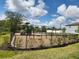 Community playground with swings, slides, and play equipment enclosed by a black metal fence at 10357 Scarlet Skimmer Dr, Riverview, FL 33578